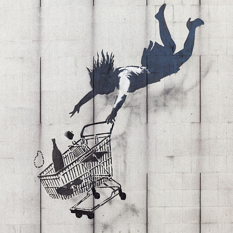 "Shop Until You Drop by Banksy" by Banksy. Licensed under CC BY-SA 3.0 via Commons